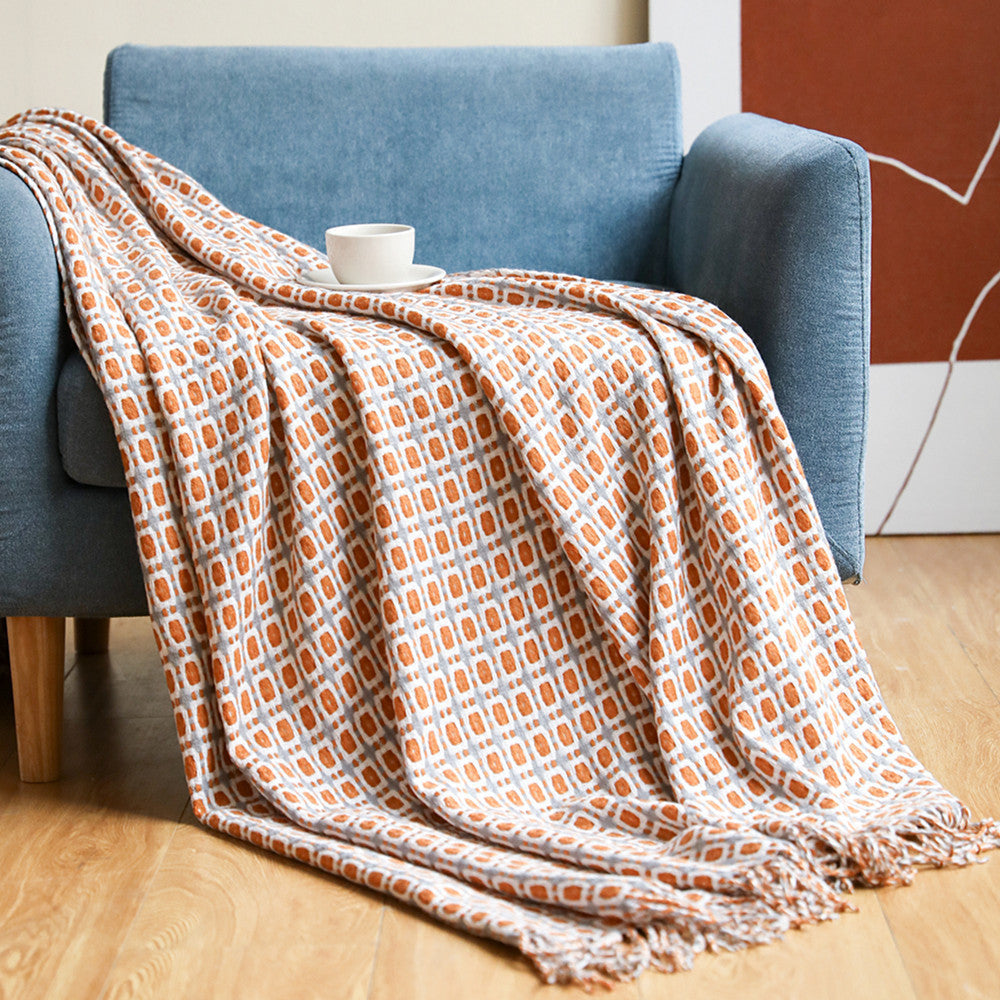 Couverture en laine à motif pied-de-poule et pompons