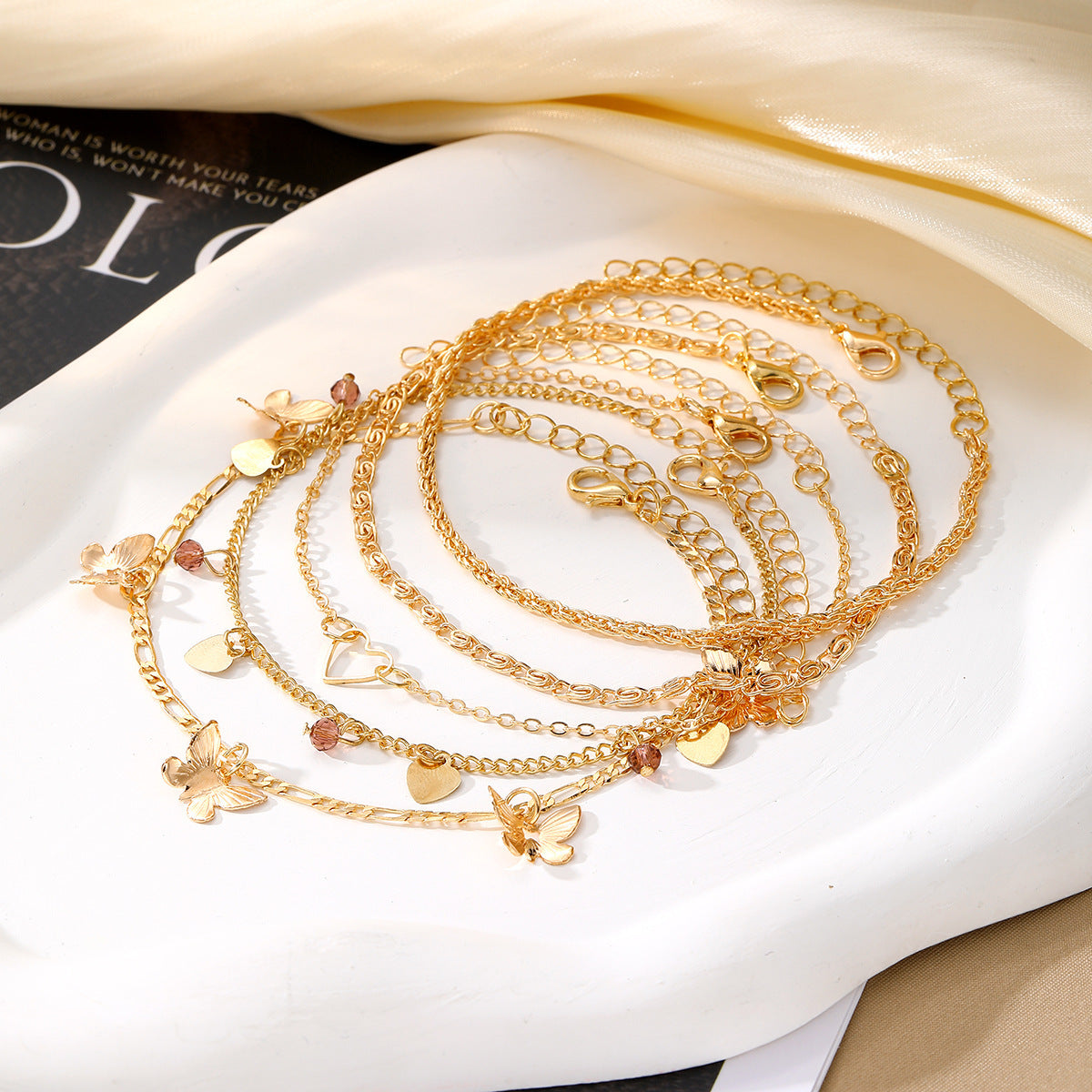 Set de cinq bracelets de cheville style plage et papillon